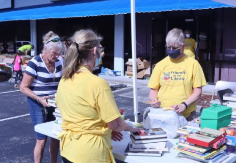 FOCCLS President Sandy Price and Vice President Janet add up a sale at a sidewalk sale