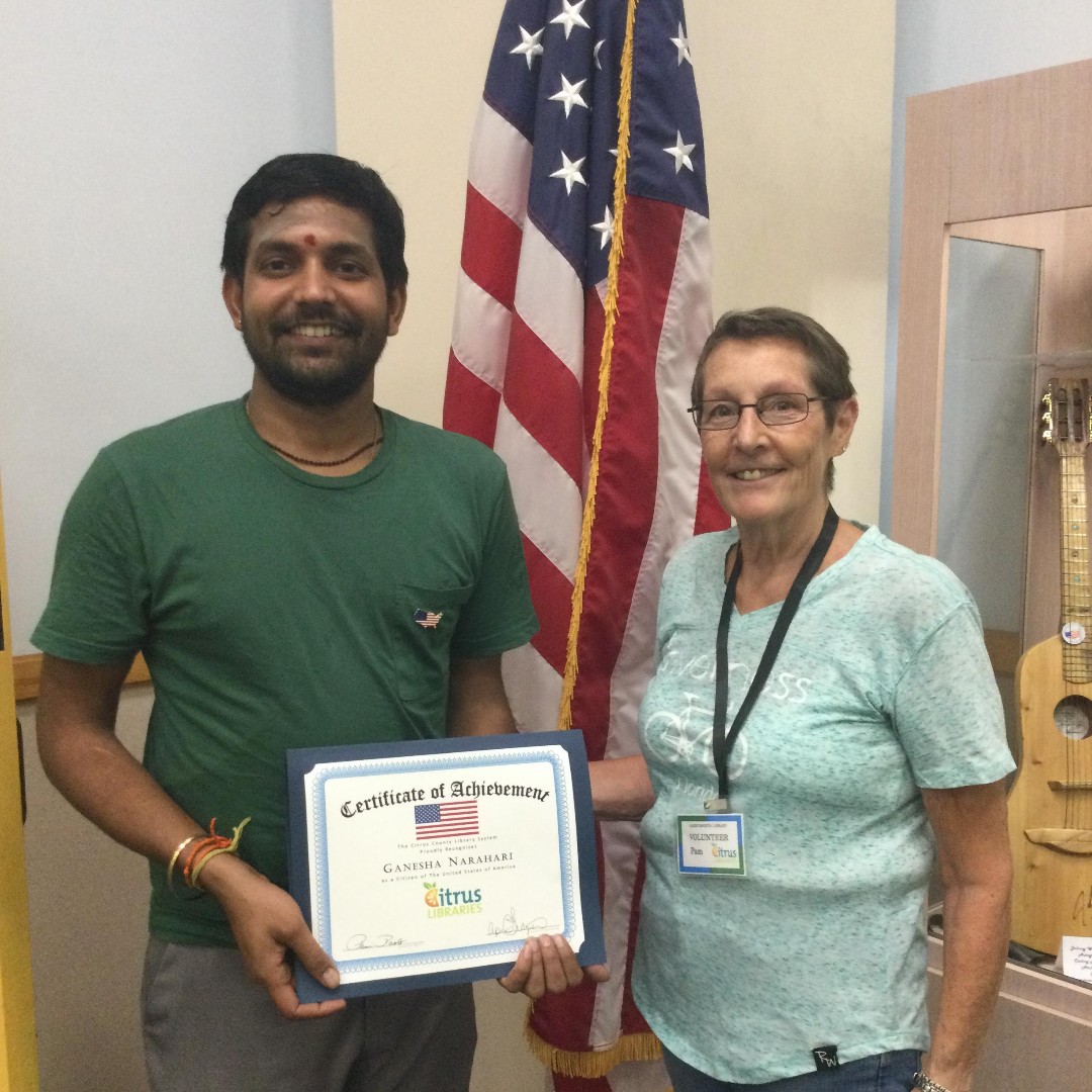 Ganesha and Tutor Pam Adult Literacy Student Ganesha holding a certificate of achievement for passing the Naturalization exam with his Tutor Pam