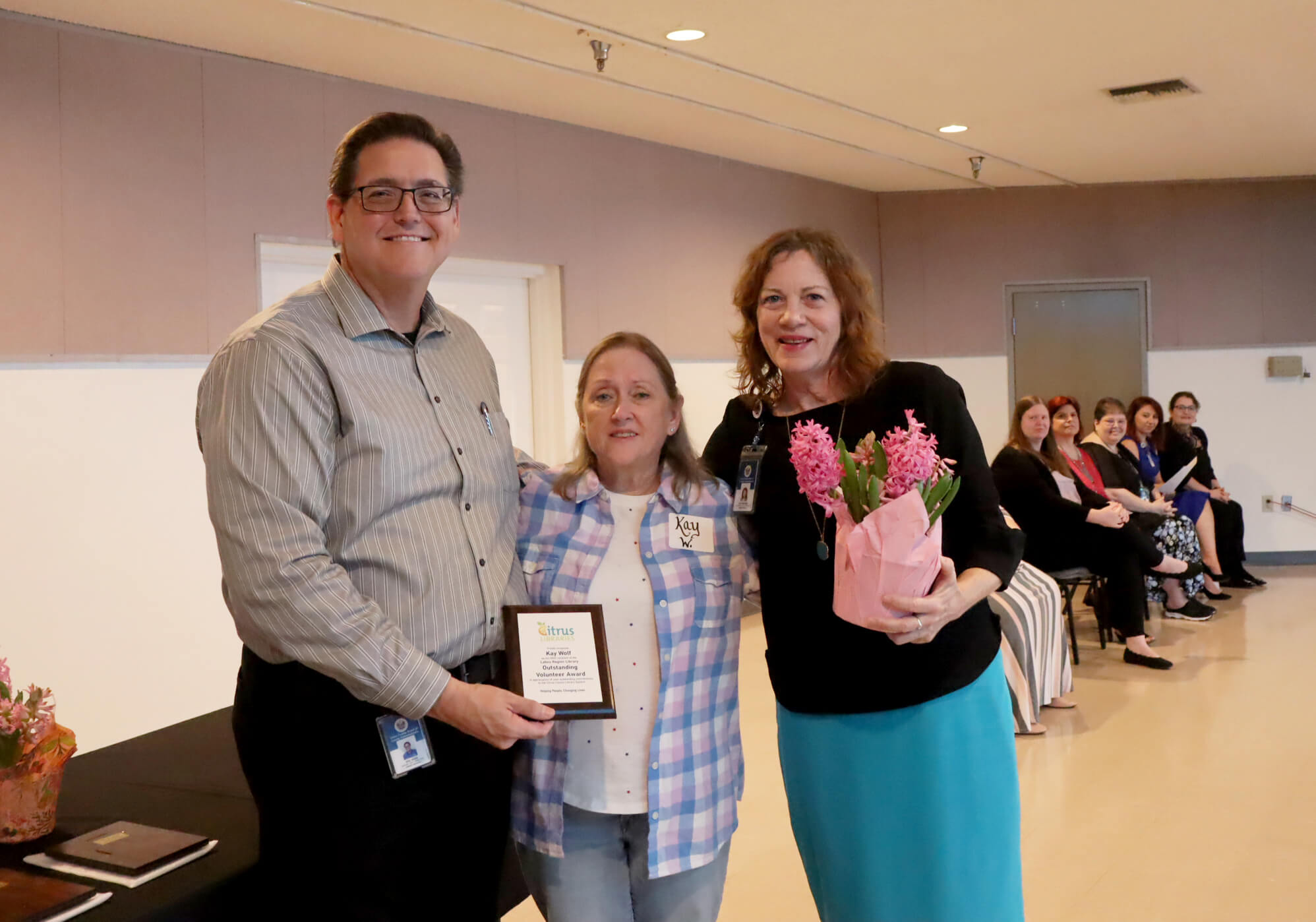 Library Director, Eric Head; Outstanding Volunteer award winner, Kay Wolf; Lakes Region Customer Service Specialist Dori Boelkens