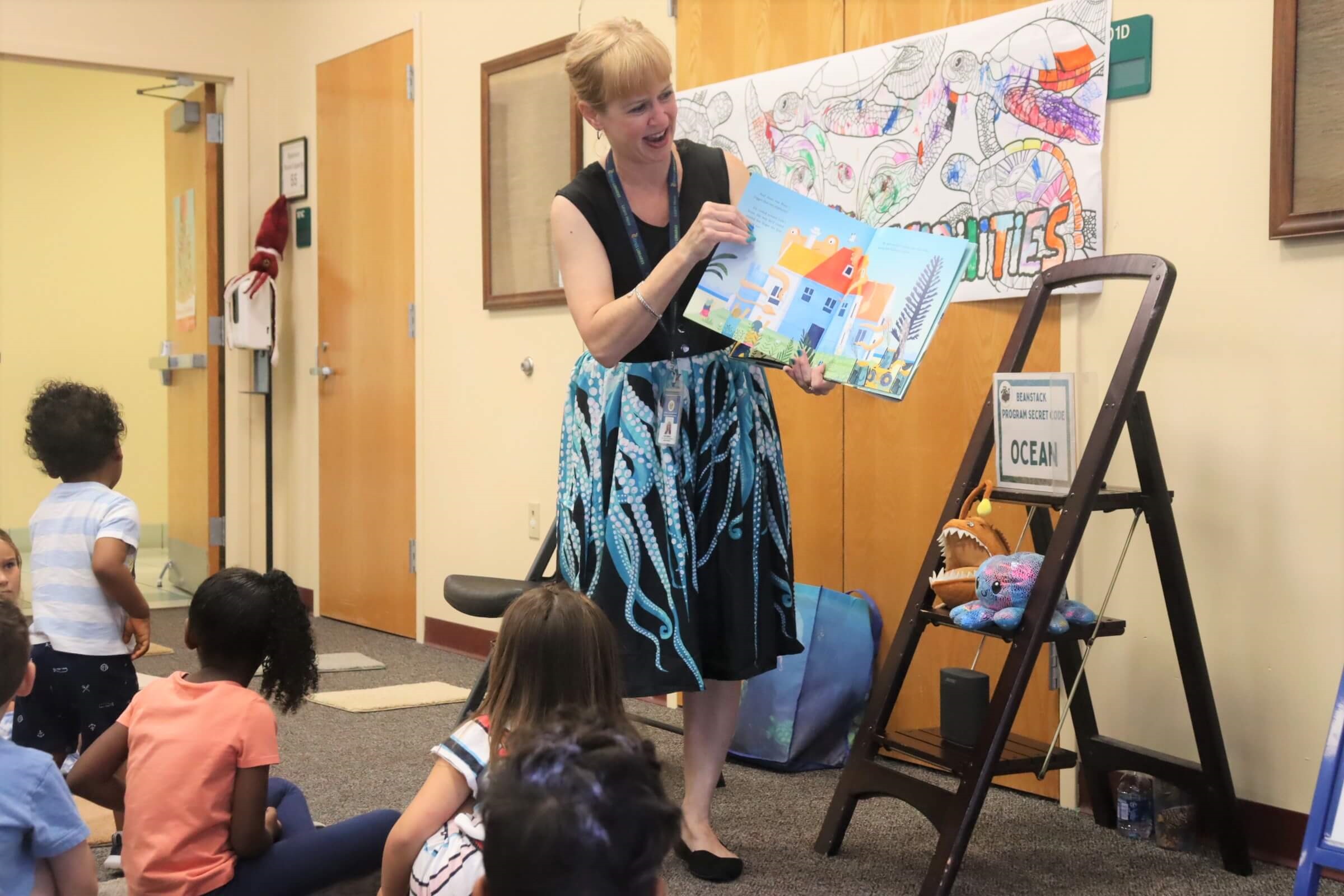 Summer Reading 2022 at Central Ridge Central Ridge Youth Librarian Kim Roberts reads aloud to attendees of the “Creature Feature” program during Summer Reading.