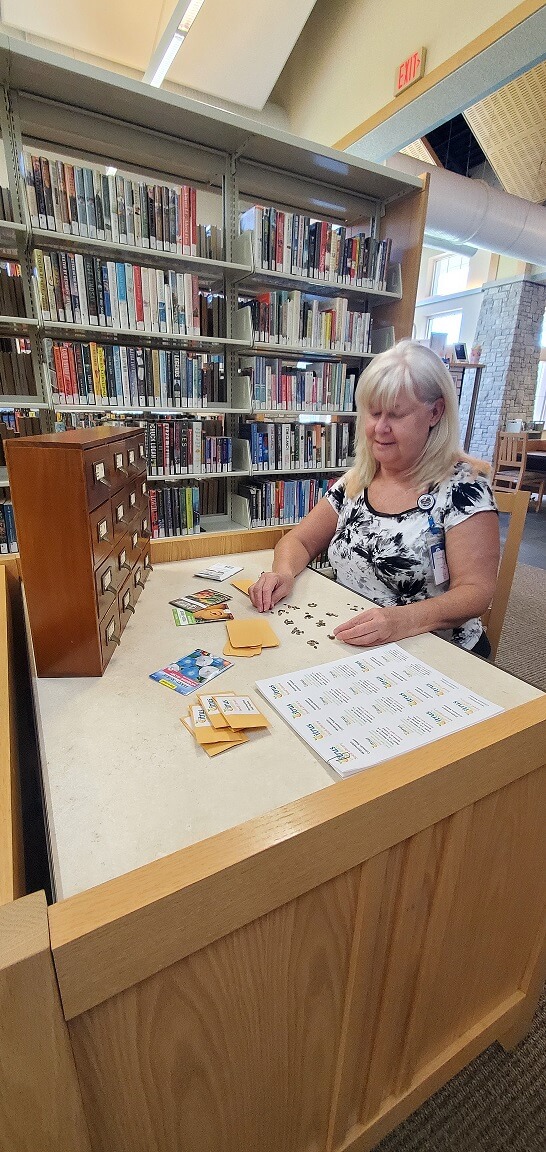 Homosassa Library Aide Donna Curtis prepares seed packets for the new Seed Library set to debut on July 5, 2022.